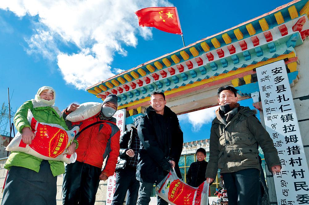 那曲地區(qū)安多縣扎仁鎮(zhèn)拉姆措村“兩委”班子成員和自治區(qū)創(chuàng)先爭(zhēng)優(yōu)強(qiáng)基惠民活動(dòng)駐那曲地區(qū)安多縣扎仁鎮(zhèn)拉姆措村駐村工作隊(duì)隊(duì)員（西藏日?qǐng)?bào)社派駐）一起幫助低保戶搬運(yùn)物資。記者 潘多 馮驥 攝