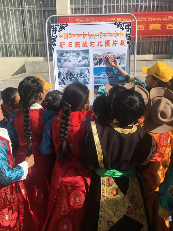 集體活動結(jié)束后，各班排隊(duì)參觀新舊西藏對比圖片展。圖為五年級的歐珠旺姆和央青措姆擔(dān)任解說員，分別為同學(xué)們講解新舊西藏圖片。.JPG